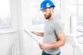 Repairman with drawings in the apartment Royalty Free Stock Photo