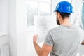 Repairman with drawings in the apartment Royalty Free Stock Photo