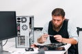 Repairman examine inside part of computer