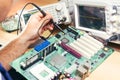 Repairman fixes electronic equipment in service center Royalty Free Stock Photo