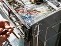 Repairman fixes panel of old stove during repair