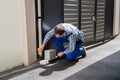 Repairman Fixing Broken Automatic Door