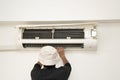 Repairman fixing and cleaning air conditioner unit Royalty Free Stock Photo