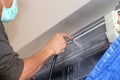 Repairman fixing and cleaning air conditioner unit Royalty Free Stock Photo