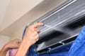 Repairman fixing and cleaning air conditioner unit Royalty Free Stock Photo