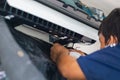 Repairman fixing and cleaning air conditioning system, Air Conditioning Repair, Male technician service for repair and maintenance Royalty Free Stock Photo