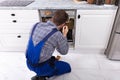 Repairman Fixing Dishwasher With Digital Multimeter Royalty Free Stock Photo