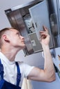 Repairman fixing kitchen extractor fan Royalty Free Stock Photo