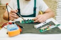 Repairman fixing problem with refrigerator at home