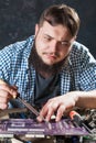 Repairman fixing problem with soldering tool