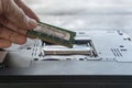 Repairman fixing and repair memory ram or setup hardware for the computer on laptop motherboard with his hands Royalty Free Stock Photo