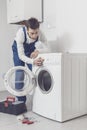 Professional repairman fixing a washing machine