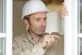 repairman fixing window with screwdriver Royalty Free Stock Photo