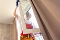 A repairman fixing windows in new apartment. Royalty Free Stock Photo