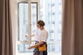 A repairman fixing windows in new apartment. Royalty Free Stock Photo