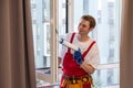 A repairman fixing windows in new apartment. Royalty Free Stock Photo