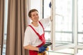 A repairman fixing windows in new apartment. Royalty Free Stock Photo