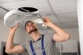 Repairman with flashlight fixing ventilation system Royalty Free Stock Photo