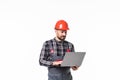 Repairman in hemlet using laptop against white background Royalty Free Stock Photo