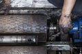 repairman holding a wrench and tighten and during maintenance work of machine