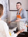 Repairman and housewife at kitchen Royalty Free Stock Photo