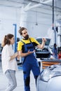 Repairman informs client of car issues Royalty Free Stock Photo