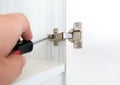 Repairman install cabinet hinge