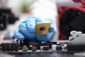 Repairman installing computer processor into motherboard closeup