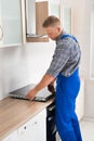 Repairman Installing Induction Cooker Royalty Free Stock Photo