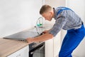 Repairman Installing Induction Cooker Royalty Free Stock Photo