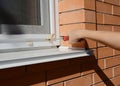 Repairman installing mosquito wire screen on house window Royalty Free Stock Photo