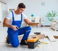 Repairman laying laminate flooring at home Royalty Free Stock Photo