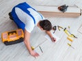 Repairman laying laminate flooring at home Royalty Free Stock Photo