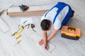 The repairman laying laminate flooring at home Royalty Free Stock Photo