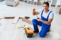 The repairman laying laminate flooring at home Royalty Free Stock Photo