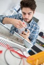 Repairman makes maintenance works on radiator