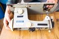 Man is looking inside sewing machine trying to repair it, hands closeup. Royalty Free Stock Photo