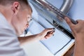 Repairman mending a kitchen extractor Royalty Free Stock Photo