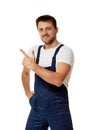 Repairman in overalls pointing at copy space. Royalty Free Stock Photo