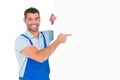 Repairman in overalls pointing at placard Royalty Free Stock Photo