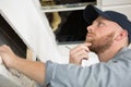 repairman repairing ceiling air conditioning unit Royalty Free Stock Photo