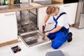 Repairman Repairing Dishwasher Royalty Free Stock Photo