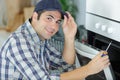 repairman repairing oven Royalty Free Stock Photo