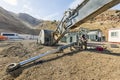 Repairman is repairing to hydraulic piston of the excavator with covered elektrode in the construction site. Royalty Free Stock Photo