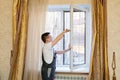 a repairman repairs, adjusts or installs metal-plastic windows in the apartment. Royalty Free Stock Photo