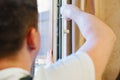 a repairman repairs, adjusts or installs metal-plastic windows in the apartment. Royalty Free Stock Photo