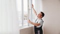 a repairman repairs, adjusts or installs metal-plastic windows in the apartment. Royalty Free Stock Photo