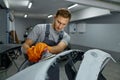 Repairman with sander removing old paint car Royalty Free Stock Photo