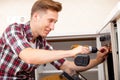 Repairman set the oven in the kitchen Royalty Free Stock Photo