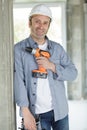 Repairman smiling and posing with power drill Royalty Free Stock Photo